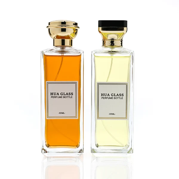 HUA0339 perfume bottle, tall rectangular transparent colorless glass body with beveled edges and thick base, 200 ml liquid, flat-top geometric plastic cap in glossy black or gold finish with layered cylindrical base, no bottle neck, brand logo label on bottle surface, modern luxury minimalist design, ideal for gifting and daily use.