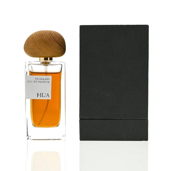 HUA0016 perfume bottle, heavy-base rectangular cuboid glass bottle with clear finish, featuring a square paper label, a polished gold neck, and an organic pebble-shaped timber cap with a natural smooth grain finish, elegant modern fragrance packaging design available in 30ml, 50ml, and 100ml