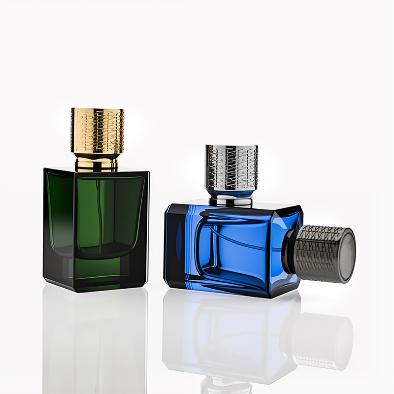 HUA0308 perfume bottle, semi-transparent blue or dark green customizable glass body with thick base and clean rectangular silhouette, 30 ml, 50 ml, or 100 ml liquid, textured cylindrical plastic cap in gold or black finish, gold or white printed logo on bottle surface, modern masculine luxury design, ideal for gifting and daily use.