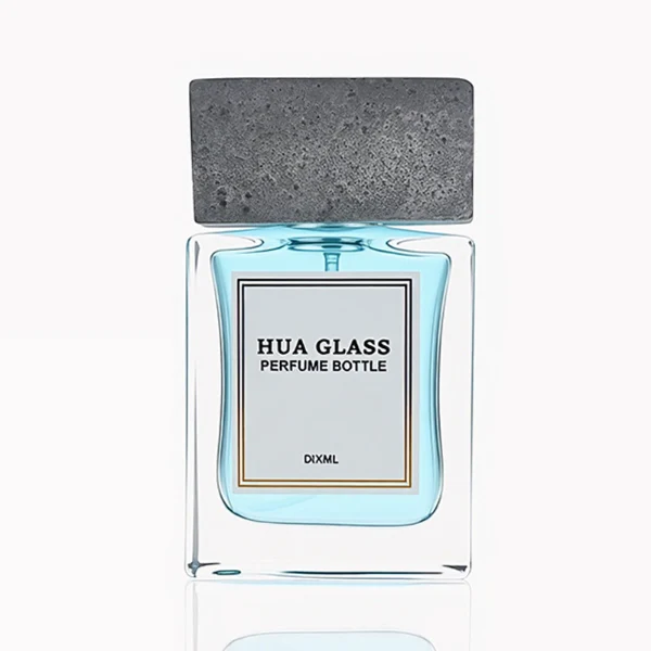 HUA0341 perfume bottle, rectangular transparent colorless glass body with thick base and curved inner contour, 50 ml liquid, oversized rectangular artificial stone cap with matte textured surface, no bottle neck, brand logo label attached on bottle surface, modern architectural luxury design, ideal for gifting and daily use.