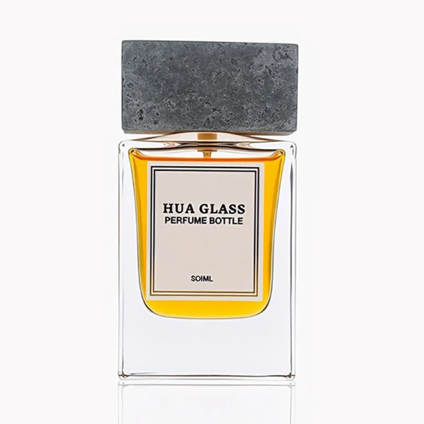 HUA0341 perfume bottle, rectangular transparent colorless glass body with thick base and curved inner contour, 50 ml liquid, oversized rectangular artificial stone cap with matte textured surface, no bottle neck, brand logo label attached on bottle surface, modern architectural luxury design, ideal for gifting and daily use.