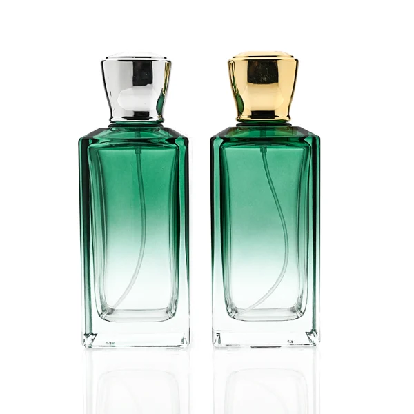 HUA0346 perfume bottle, rectangular transparent colorless glass body with gradient blue, green, or amber tint, 100 ml liquid, glossy square plastic cap with smooth curved sides, no bottle neck, gold printed brand logo on bottle surface, modern luxury minimalist design, ideal for gifting and daily use.