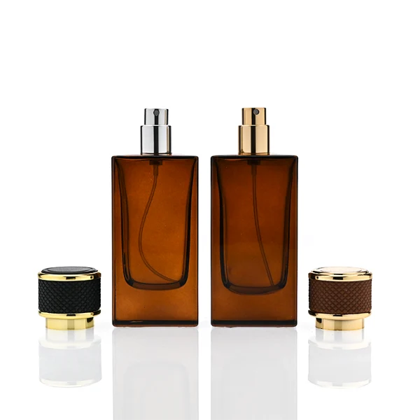 HUA0347 perfume bottle, rectangular amber glass body with thick base and smooth beveled edges, gold plastic cap wrapped in black or brown leather, luxury minimalist fragrance packaging design, ideal for gifting and personal fragrance use