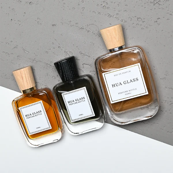 HUA0348 perfume bottle, rounded rectangular clear glass body with thick base, tapered wooden cap available in black, brown, or natural wood color, optional gold or silver collar, modern minimalist luxury fragrance packaging design