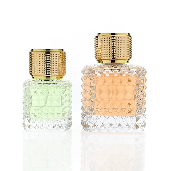 HUA0349 perfume bottle, embossed round clear glass body with aluminum label plate, layered ring edge details, textured metallic cylindrical cap, luxury vintage fragrance packaging design