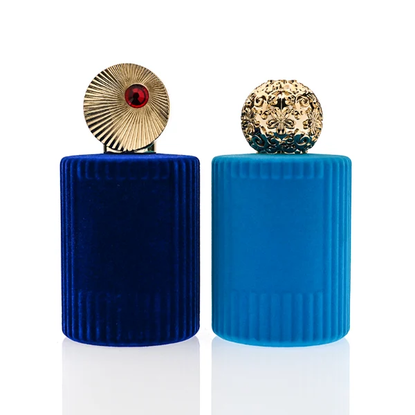 HUA0351 perfume bottle, velvet wrapped cylindrical glass body with gold aluminum label plate, decorative metallic zamak cap with sunburst texture or irregular cylindrical shape, luxury artistic vintage fragrance packaging design
