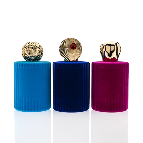 HUA0351 perfume bottle, velvet wrapped cylindrical glass body with gold aluminum label plate, decorative metallic zamak cap with sunburst texture or irregular cylindrical shape, luxury artistic vintage fragrance packaging design