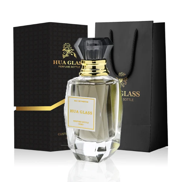 HUA0352 perfume bottle, multi-faceted geometric cut glass body with clear or black diamond-shaped plastic cap and gold collar, minimalist paper label with elegant gold lettering, modern luxury fragrance packaging design