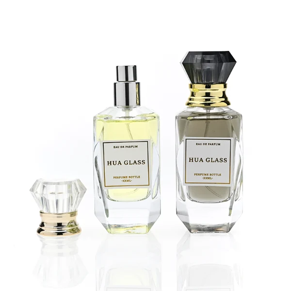 HUA0352 perfume bottle, multi-faceted geometric cut glass body with clear or black diamond-shaped plastic cap and gold collar, minimalist paper label with elegant gold lettering, modern luxury fragrance packaging design