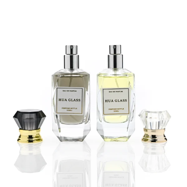HUA0352 perfume bottle, multi-faceted geometric cut glass body with clear or black diamond-shaped plastic cap and gold collar, minimalist paper label with elegant gold lettering, modern luxury fragrance packaging design