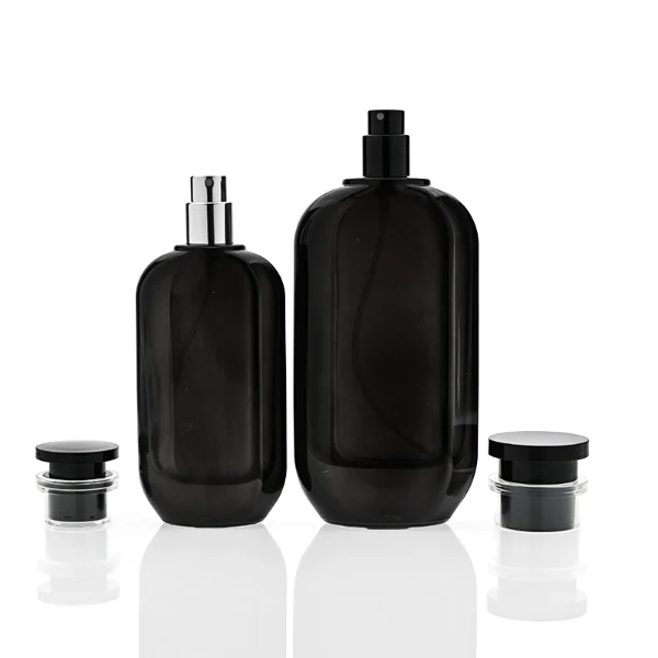HUA0354 perfume bottle, cylindrical glass body in black, green, and blue with vertical gold printed logo, black plastic cap with a transparent accent ring, modern bold luxury fragrance packaging design available in 50ml and 100ml
