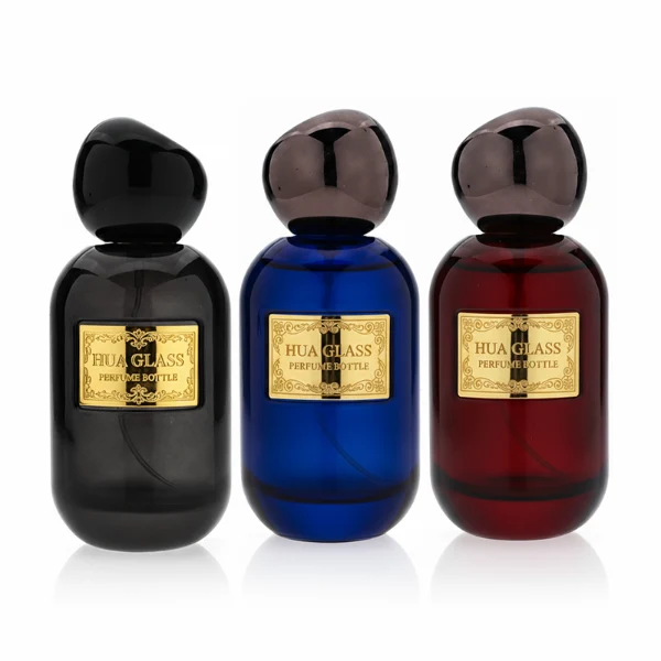 HUA0355 perfume bottle, colored cylindrical glass body in amber brown, purple, and burgundy red with gold aluminum label plate, irregular sculptural pebble plastic cap, luxury artistic vintage fragrance packaging design