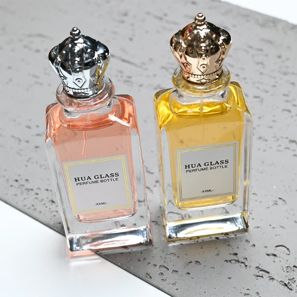 HUA0356 perfume bottle, rectangular cuboid clear glass body with ornate engraved gold or silver royal crown cap, centered paper label with elegant border, luxury imperial vintage fragrance packaging design