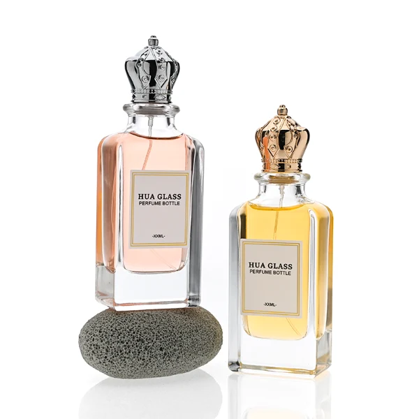 HUA0356 perfume bottle, rectangular cuboid clear glass body with ornate engraved gold or silver royal crown cap, centered paper label with elegant border, luxury imperial vintage fragrance packaging design