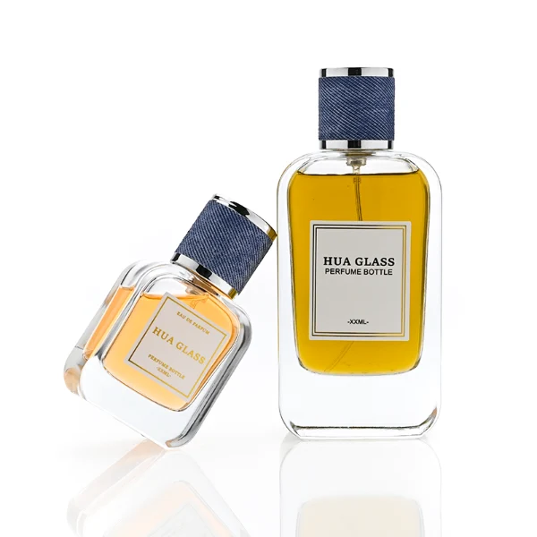 HUA0360 perfume bottle, flat rectangular clear glass body with silver neck and a paper label attached, textured blue or beige cylindrical plastic cap with silver trim, contemporary casual luxury fragrance packaging design available in 30ml, 50ml, and 100ml