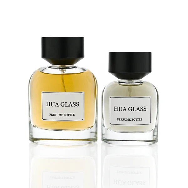 HUA0361 perfume bottle, round cylindrical clear glass body with a paper label attached, matte black inverted cone plastic cap, contemporary minimalist luxury fragrance packaging design available in 50ml and 100ml