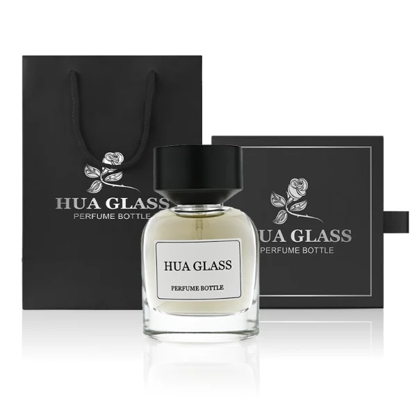 HUA0361 perfume bottle, round cylindrical clear glass body with a paper label attached, matte black inverted cone plastic cap, contemporary minimalist luxury fragrance packaging design available in 50ml and 100ml