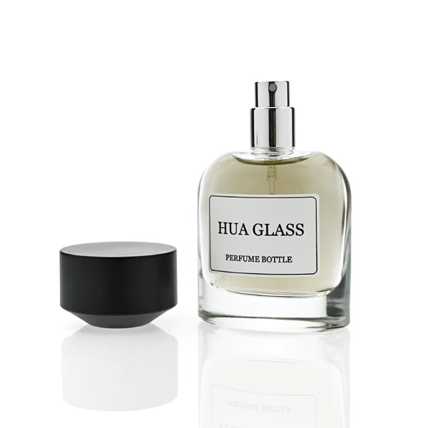 HUA0361 perfume bottle, round cylindrical clear glass body with a paper label attached, matte black inverted cone plastic cap, contemporary minimalist luxury fragrance packaging design available in 50ml and 100ml