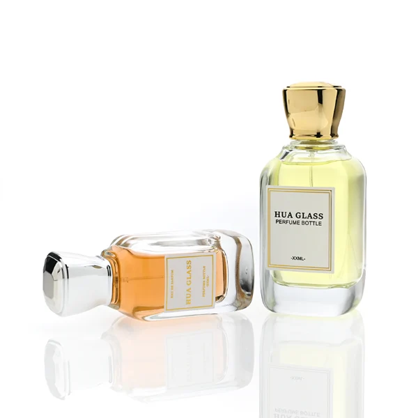 HUA0363 perfume bottle, flat rectangular clear glass body with centered paper label, elegant trophy-shaped plastic cap in gold or silver finish, royal classic luxury fragrance packaging design available in 50ml and 100ml