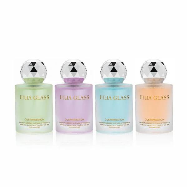 HUA0368 perfume bottle, frosted cylindrical glass body in translucent peach, purple, and blue with gold printed logo, spherical multi-faceted diamond-cut plastic cap in shiny silver finish, dreamy modern luxury fragrance packaging design available in 30ml, 50ml, and 100ml