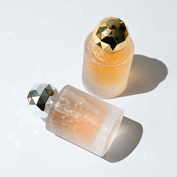 HUA0368 perfume bottle, frosted cylindrical glass body in translucent peach, purple, and blue with gold printed logo, spherical multi-faceted diamond-cut plastic cap in shiny silver finish, dreamy modern luxury fragrance packaging design available in 30ml, 50ml, and 100ml