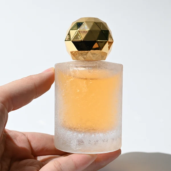 HUA0368 perfume bottle, frosted cylindrical glass body in translucent peach, purple, and blue with gold printed logo, spherical multi-faceted diamond-cut plastic cap in shiny silver finish, dreamy modern luxury fragrance packaging design available in 30ml, 50ml, and 100ml