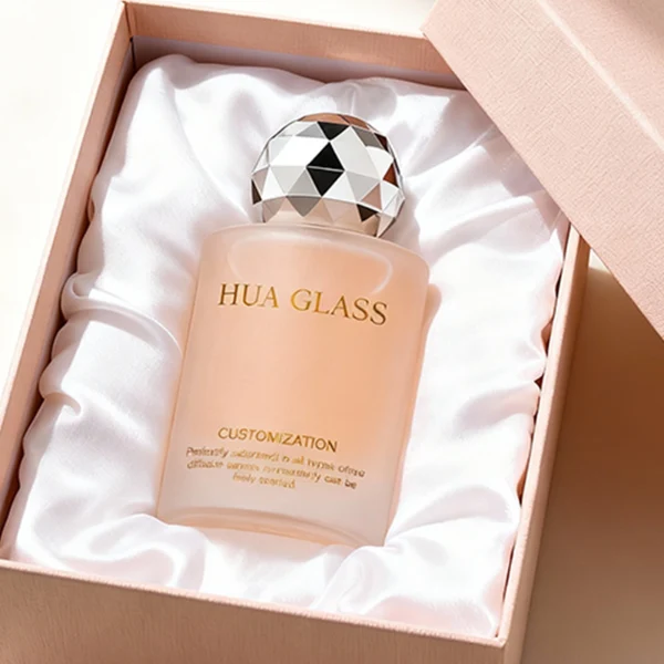 HUA0368 perfume bottle, frosted cylindrical glass body in translucent peach, purple, and blue with gold printed logo, spherical multi-faceted diamond-cut plastic cap in shiny silver finish, dreamy modern luxury fragrance packaging design available in 30ml, 50ml, and 100ml