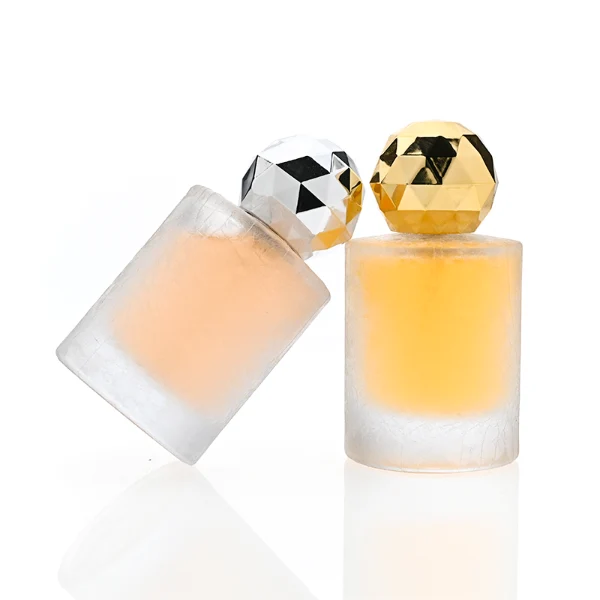 HUA0368 perfume bottle, frosted cylindrical glass body in translucent peach, purple, and blue with gold printed logo, spherical multi-faceted diamond-cut plastic cap in shiny silver finish, dreamy modern luxury fragrance packaging design available in 30ml, 50ml, and 100ml