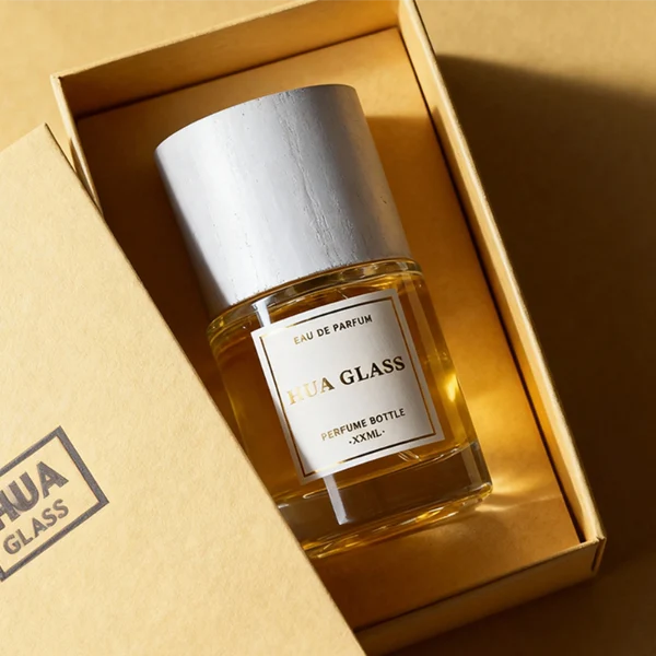 HUA0370 perfume bottle, cylindrical clear glass body with centered paper label, silver neck and silver pump, straight cylindrical wooden cap in matte black or light white natural wood grain texture, eco-friendly modern luxury fragrance packaging design available in 30ml, 50ml, and 100ml