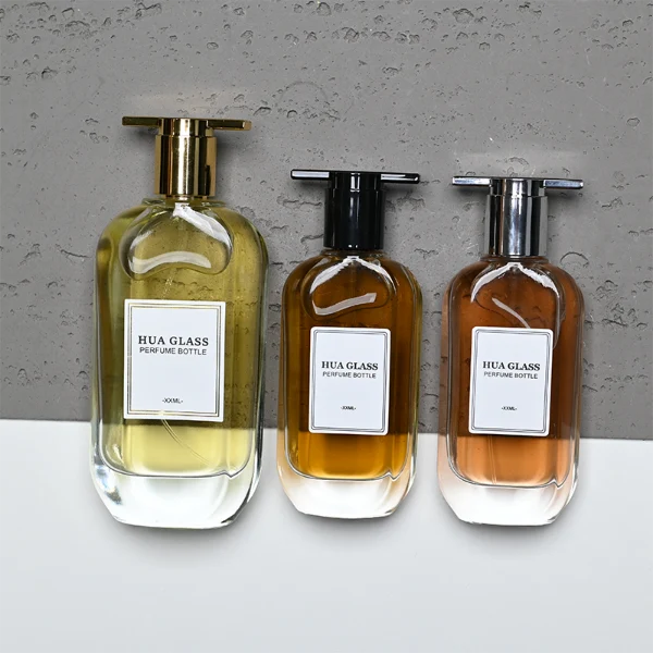 HUA0372 perfume bottle, oval oblong clear glass body with centered paper label, unique architectural T-shaped plastic cap with flat horizontal bar top in shiny silver or glossy black, contemporary minimalist luxury fragrance packaging design available in 50ml and 100ml