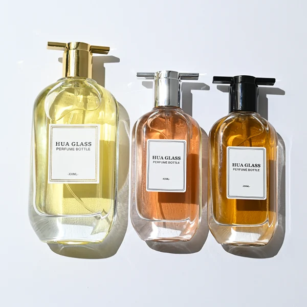 HUA0372 perfume bottle, oval oblong clear glass body with centered paper label, unique architectural T-shaped plastic cap with flat horizontal bar top in shiny silver or glossy black, contemporary minimalist luxury fragrance packaging design available in 50ml and 100ml