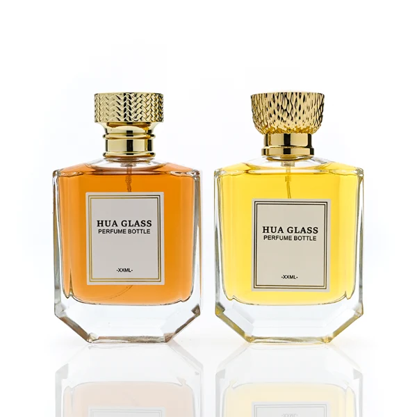 HUA0374 perfume bottle, flat hexagonal multi-faceted clear glass body with gold neck and centered paper label, textured inverted trapezoid gold plastic cap in grid knurled or chevron ribbed patterns matching the gold neck, Art Deco luxury fragrance packaging design in 100ml