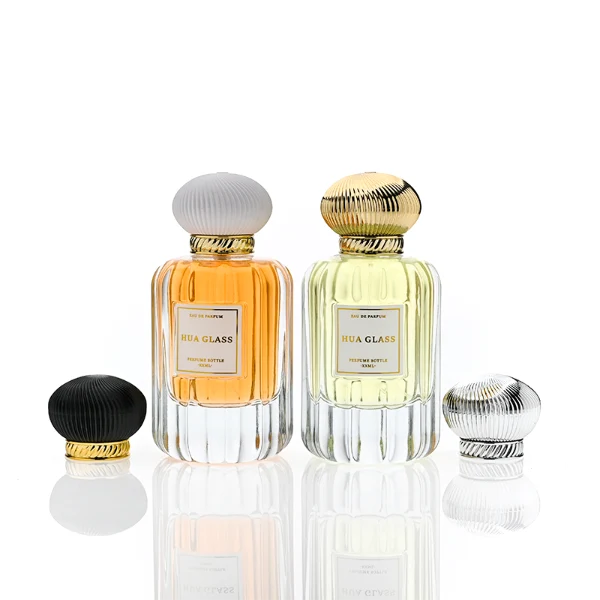 HUA0376 perfume bottle, vertical fluted clear glass body with diagonal twisted gold neck and centered paper label, swirling textured pumpkin-shaped plastic cap in shiny gold with black lines or matte white, neoclassical luxury fragrance packaging design available in 50ml and 100ml