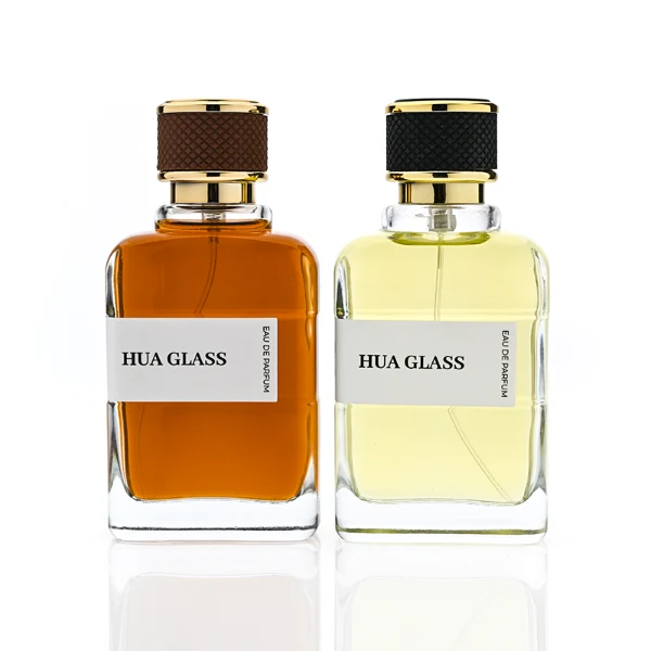 HUA0377 perfume bottle, flat rectangular cuboid clear glass body with gold neck and wrapped paper label, textured diamond knurled cylindrical plastic cap with gold trim in dark brown or black, modern industrial luxury fragrance packaging design in 100ml