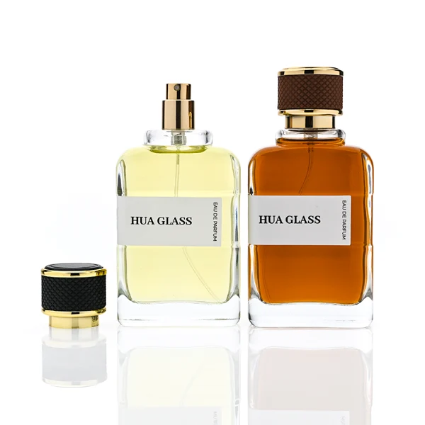 HUA0377 perfume bottle, flat rectangular cuboid clear glass body with gold neck and wrapped paper label, textured diamond knurled cylindrical plastic cap with gold trim in dark brown or black, modern industrial luxury fragrance packaging design in 100ml