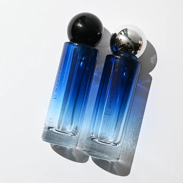 HUA0380 perfume bottle, slim cylindrical translucent glass body with colorful ombre gradient coating and white brand logo and text, sleek spherical dome plastic cap in shiny silver, modern minimalist luxury fragrance packaging design available in 30ml, 50ml, and 100ml