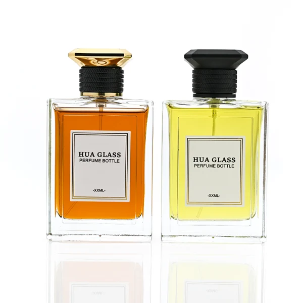 HUA0381 perfume bottle, flat rectangular cuboid clear glass body with horizontally ribbed black neck collar and centered paper label, geometric bi-conical UFO-shaped plastic cap in radiant gold or matte black, architectural luxury fragrance packaging design in 100ml