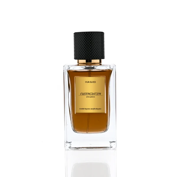 HUA0382 perfume bottle, square cubic clear glass body with architectural vertical fluting flutes, shiny gold neck and centered gold rectangular label, diamond knurled cylindrical plastic cap in deep brown or black matte finishes, luxury niche fragrance packaging design available in 50ml and 100ml