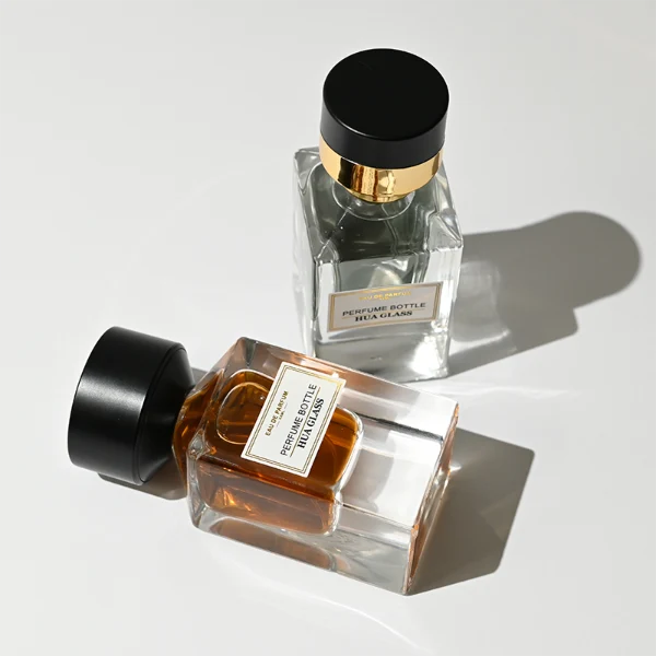 HUA0387 perfume bottle, fluted rectangular cuboid glass body with vibrant translucent amber-to-blue or pink-to-purple ombre gradient coating and centered paper label, unique slanted-top shiny black plastic cap with tiered gold neck, luxury Art Deco fragrance packaging design in 30ml