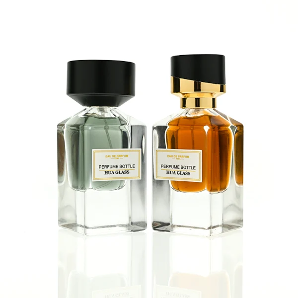 HUA0387 perfume bottle, fluted rectangular cuboid glass body with vibrant translucent amber-to-blue or pink-to-purple ombre gradient coating and centered paper label, unique slanted-top shiny black plastic cap with tiered gold neck, luxury Art Deco fragrance packaging design in 30ml