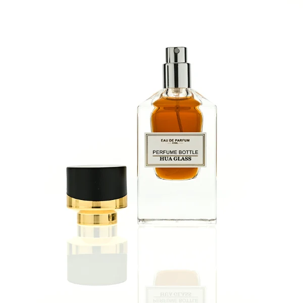 HUA0387 perfume bottle, fluted rectangular cuboid glass body with vibrant translucent amber-to-blue or pink-to-purple ombre gradient coating and centered paper label, unique slanted-top shiny black plastic cap with tiered gold neck, luxury Art Deco fragrance packaging design in 30ml