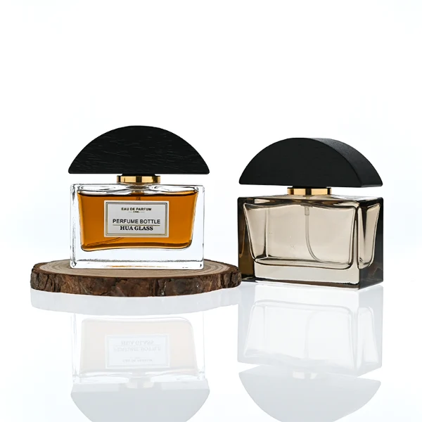 HUA0400 perfume bottle, flat rectangular cuboid glass body in transparent clear or translucent smoky black with heavy bottom and centered paper label, unique semi-circular arch-shaped wooden cap in matte black texture with shiny gold neck, modern luxury fragrance packaging design available in 30ml, 50ml, and 100ml