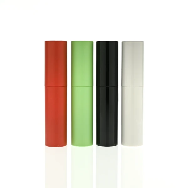 In the file HUA0404 Perfume Bottle – Slim Cylindrical Travel Atomizer with Multi-Color Matte Plastic Sleeve and Internal Glass Vial, four slim cylindrical travel atomizers are arranged inside a black gift box. The atomizers feature matte finishes in red, light green, glossy black, and white, each branded with a golden "HUA GLASS" logo.