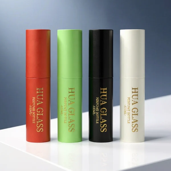 In the file HUA0404 Perfume Bottle – Slim Cylindrical Travel Atomizer with Multi-Color Matte Plastic Sleeve and Internal Glass Vial, four slim cylindrical travel atomizers are arranged inside a black gift box. The atomizers feature matte finishes in red, light green, glossy black, and white, each branded with a golden "HUA GLASS" logo.