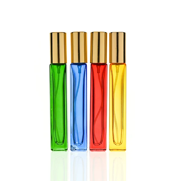 HUA0406 perfume bottle, slim cylindrical glass travel atomizer with transparent multi-color glass body in green, blue, red or yellow, featuring a luxury gold cylindrical zamak cap, modern minimalist travel fragrance packaging design available in 10ml