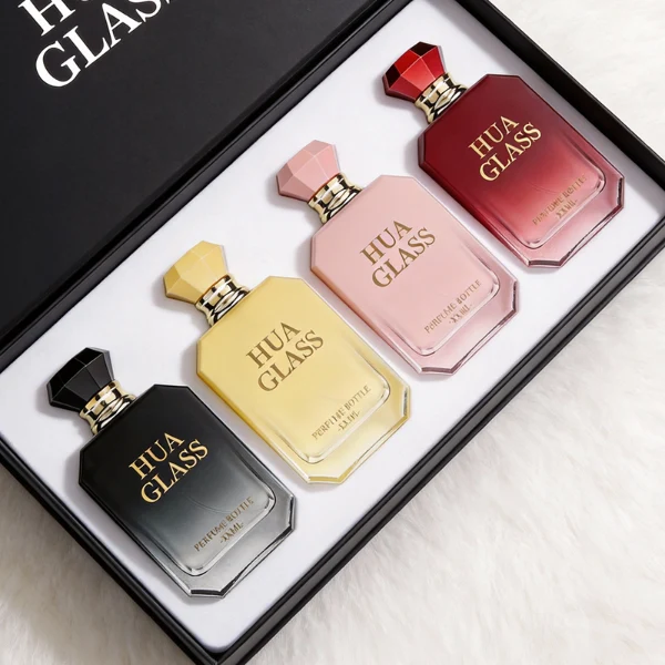 HUA0410 perfume bottle, luxury beveled corner square glass bottle with vibrant gradient or solid finish in black, yellow, pink, or red, featuring a printed gold logo, a silver-colored collar, and a faceted diamond-cut geometric plastic cap, modern elegant fragrance packaging design available in 30ml, 50ml, and 100ml