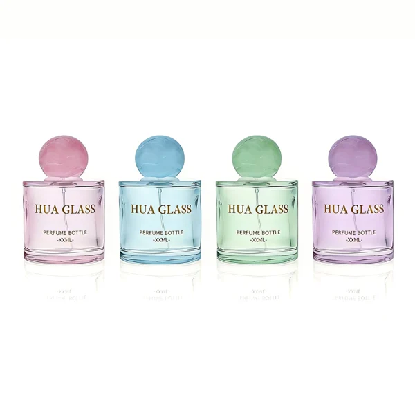 HUA0414 perfume bottle, luxury short cylindrical glass bottle with transparent pink finish, featuring a printed gold logo, a pink-colored collar, and a large round ball resin cap with a pink marble swirl pattern, modern elegant fragrance packaging design available in 30ml, 50ml, and 100ml