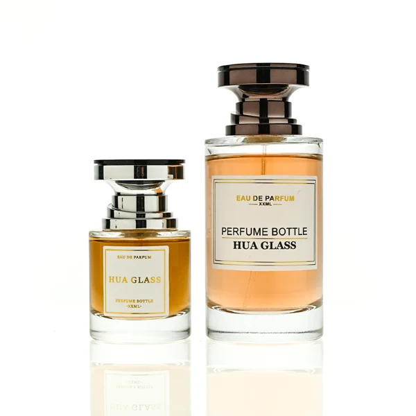 HUA0415 perfume bottle, luxury heavy-base cylindrical glass bottle with high-transparency finish showing colored liquid, featuring a gold-bordered square paper label and a unique layered hourglass-shaped plastic cap, modern elegant fragrance packaging design available in 30ml, 50ml, and 100ml
