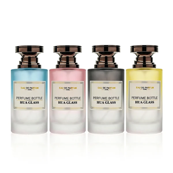 HUA0415 perfume bottle, luxury heavy-base cylindrical glass bottle with high-transparency finish showing colored liquid, featuring a gold-bordered square paper label and a unique layered hourglass-shaped plastic cap, modern elegant fragrance packaging design available in 30ml, 50ml, and 100ml