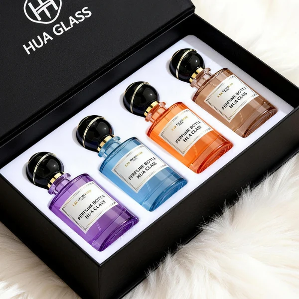 HUA0419 perfume bottle, luxury heavy-base cylindrical glass bottle with high-transparency finish showing colored liquid, featuring a gold-bordered square paper label and a unique round ball plastic cap with a diagonal gold-colored accent stripe, modern elegant fragrance packaging design available in 30ml, 50ml, and 100ml